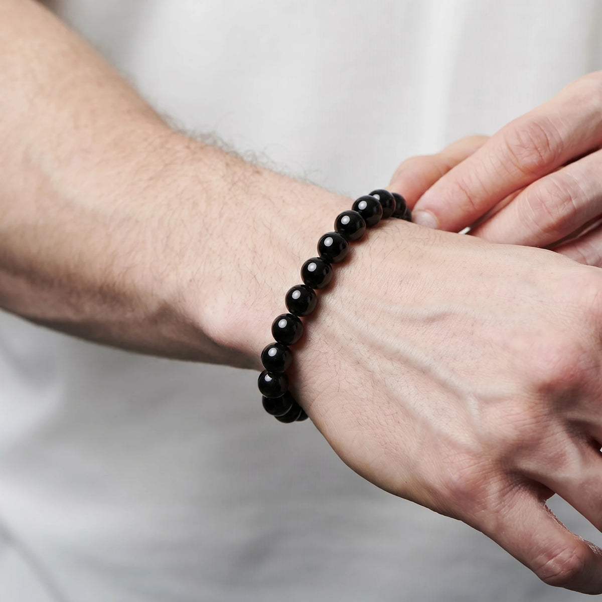 Black Obsidian 8mm Beaded Gemstone Bracelet worn on wrist – Kaashir Jewelry