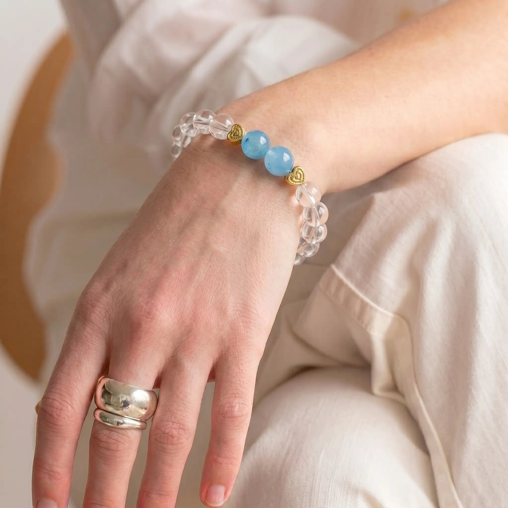 Woman wearing aquamarine & clear quartz healing crystal bracelet