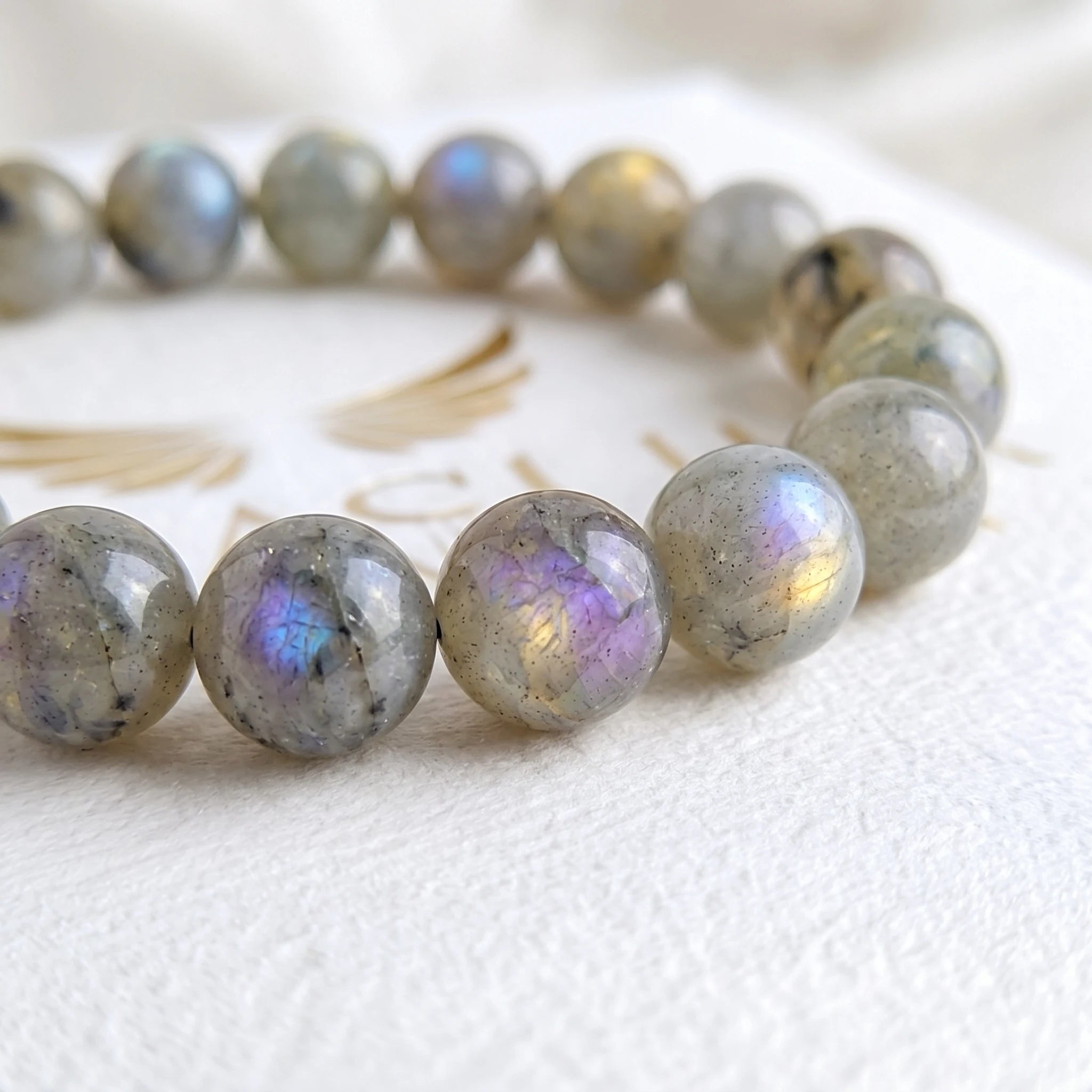 Close-up of natural labradorite beads showing colour variation — Kaashir gemstone bracelet