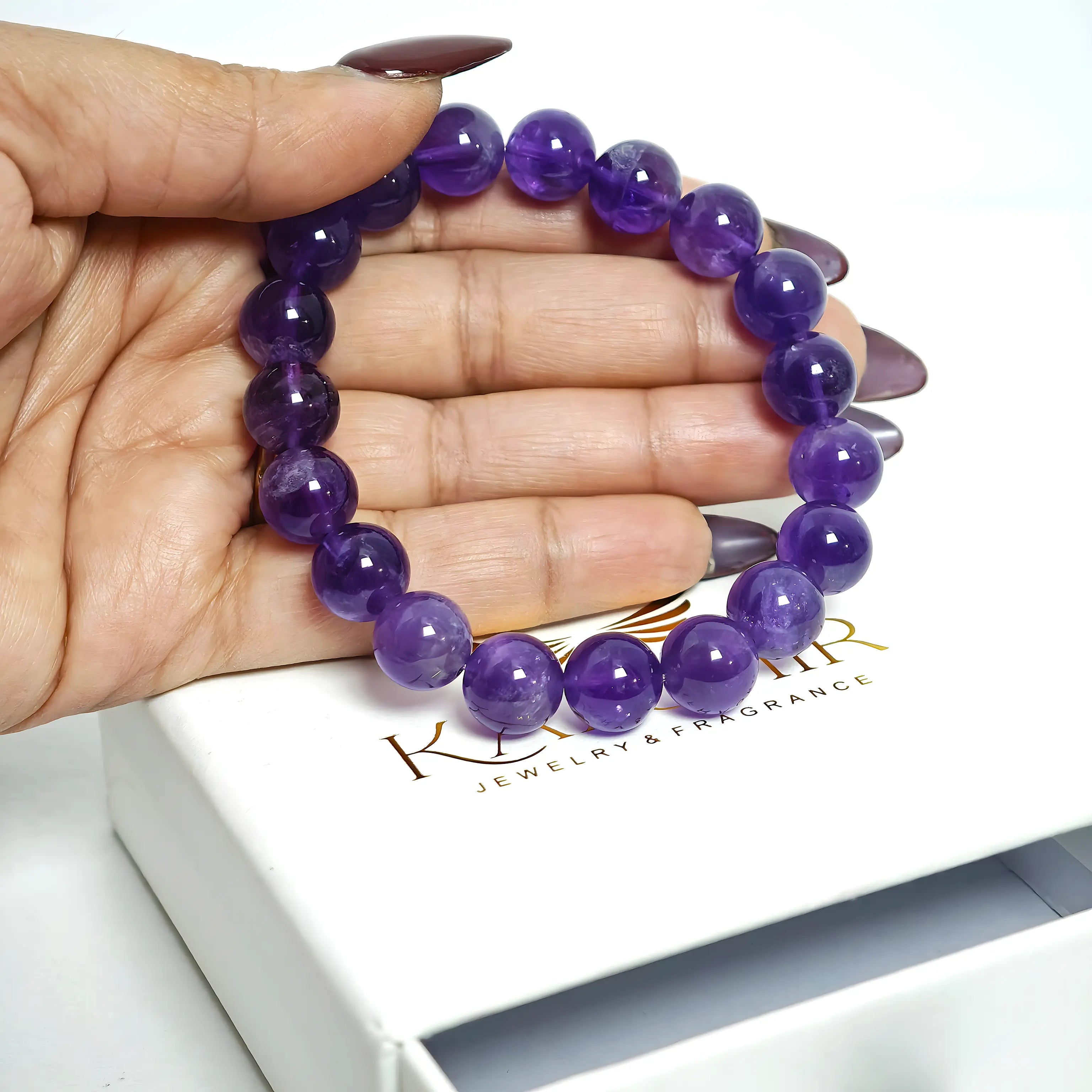 Amethyst bracelet in flat lay showing luxury aesthetic, natural deep purple stones