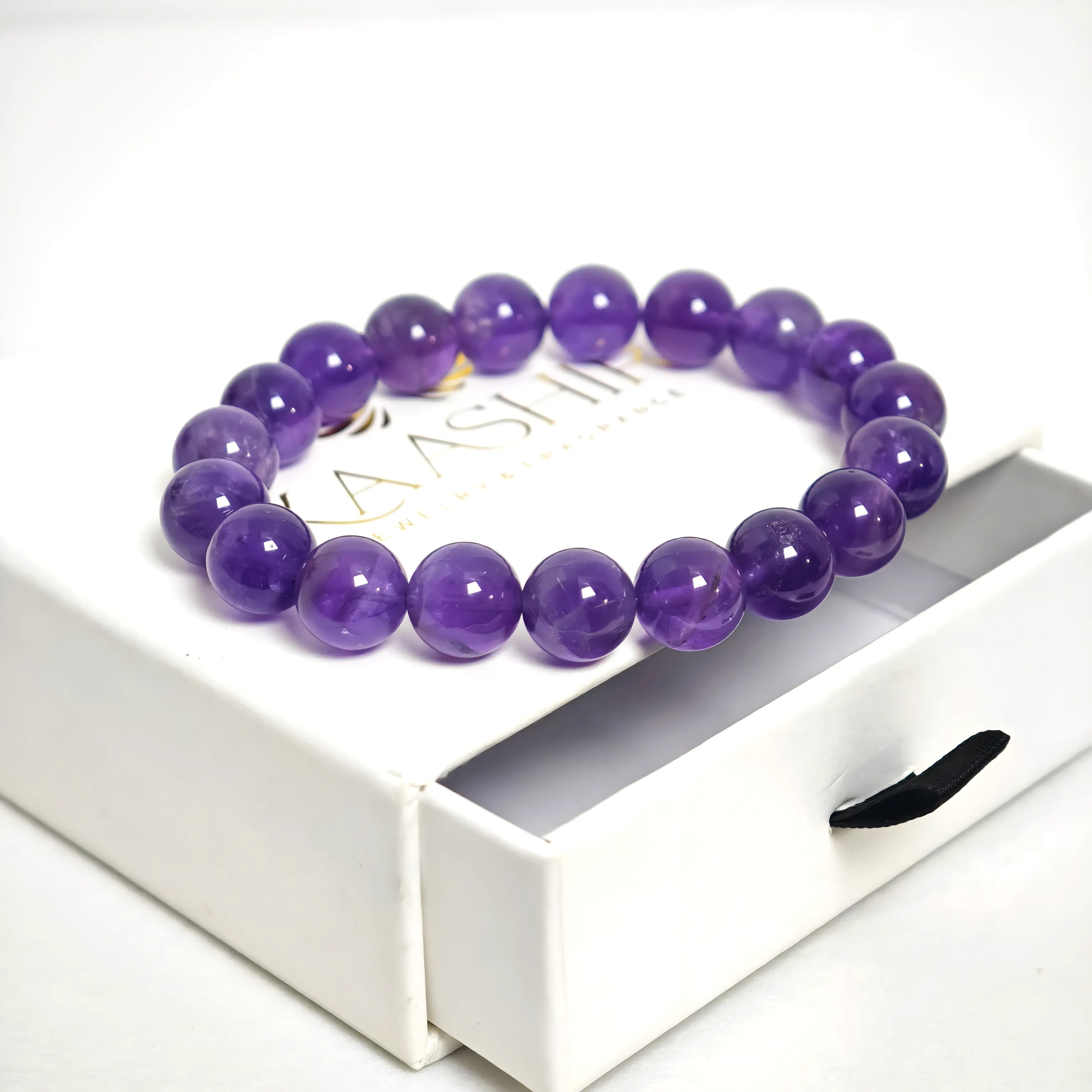 Side view of Amethyst bracelet with stretch elastic cord and polished gemstone beads
