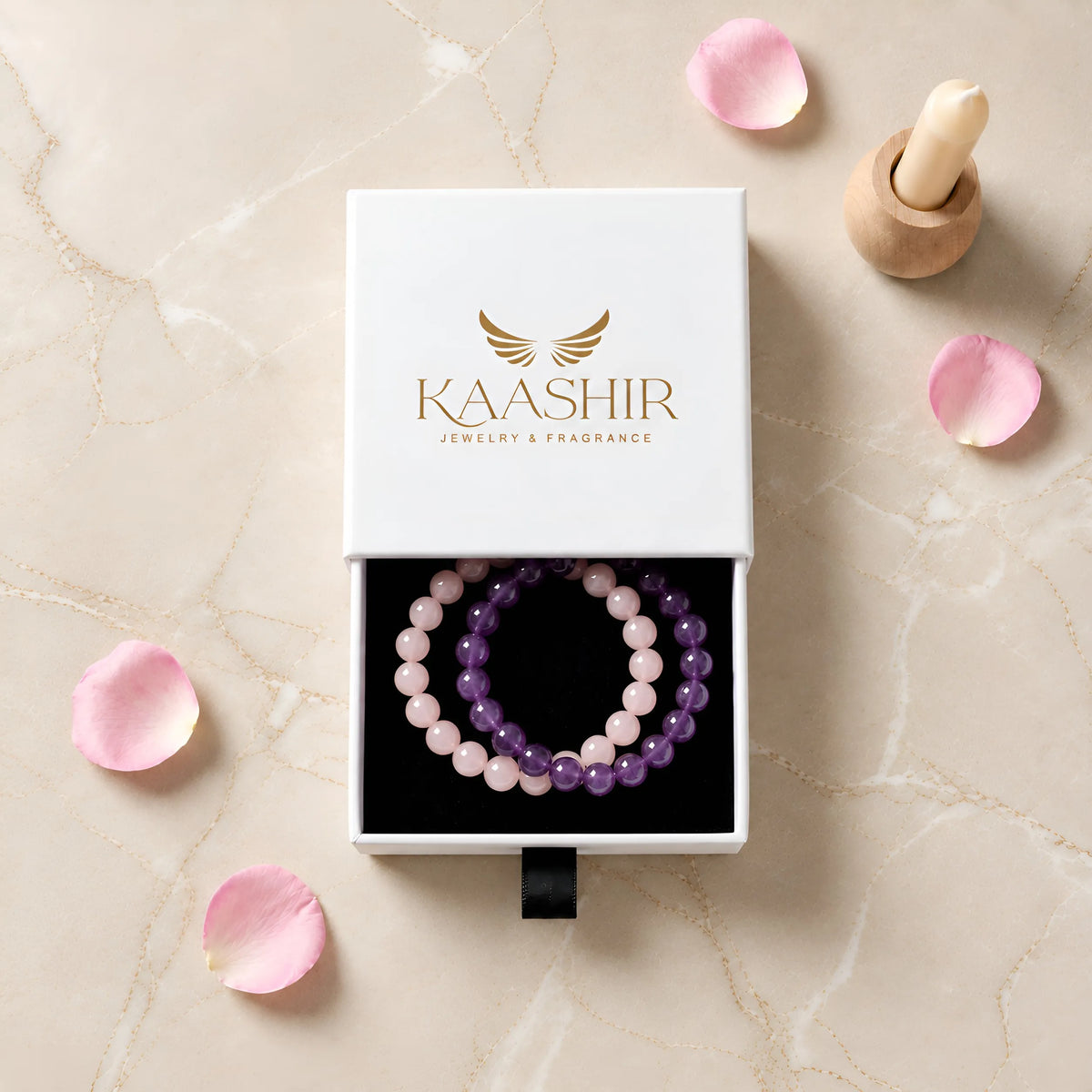 Kaashir amethyst and rose quartz bracelet set in a white drawer gift box with rose petals
