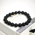 Black agate protection bracelet inside a premium jewelry gift box with a microfiber pouch.