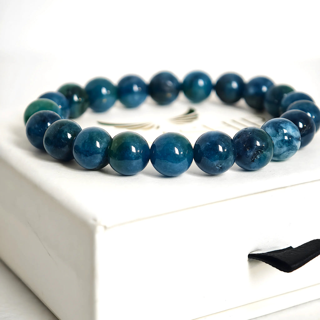 Close-up of blue apatite bracelet beads showing vibrant ocean-blue color and texture
