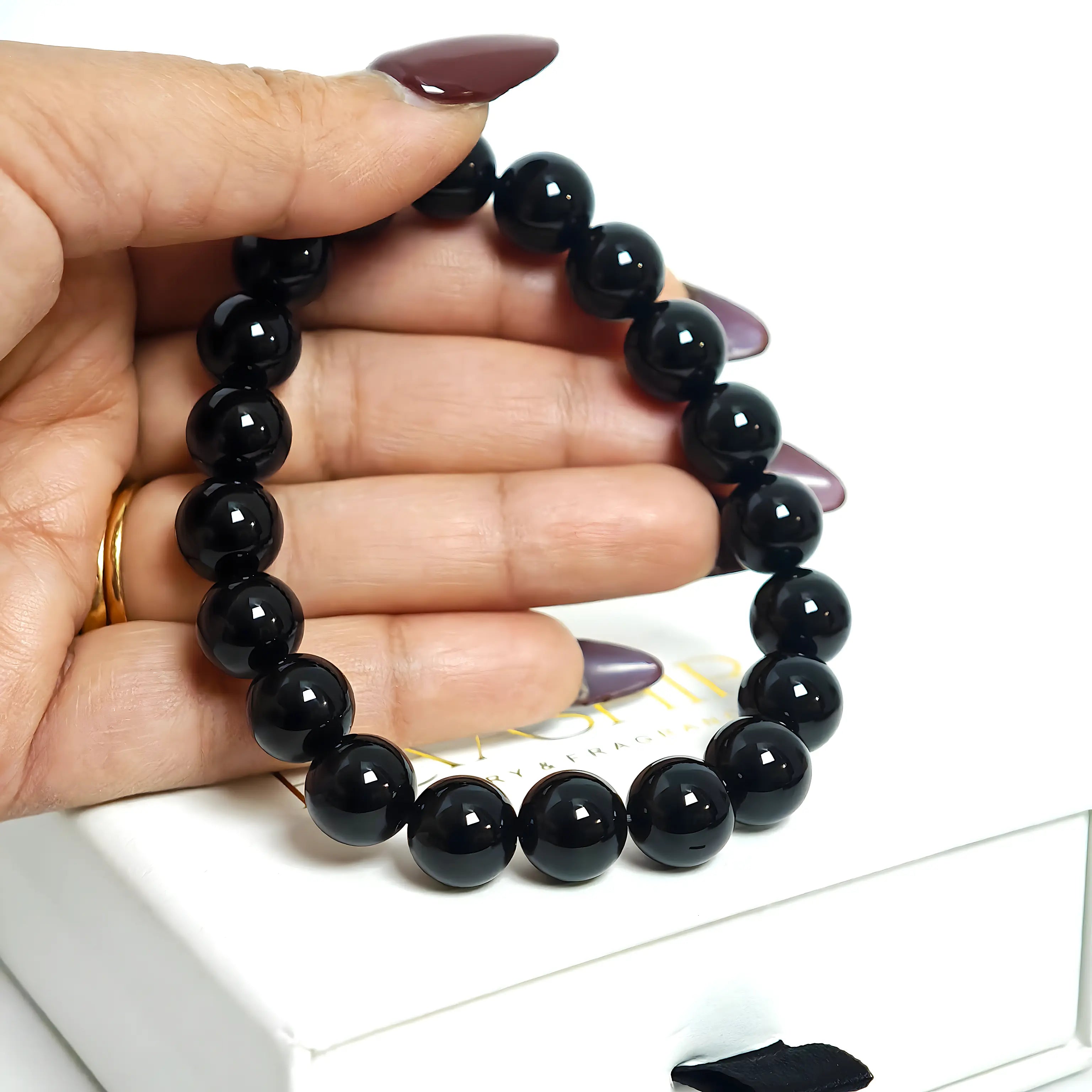 Close-up of the high-tensile elastic cord used in the black obsidian beaded bracelet.