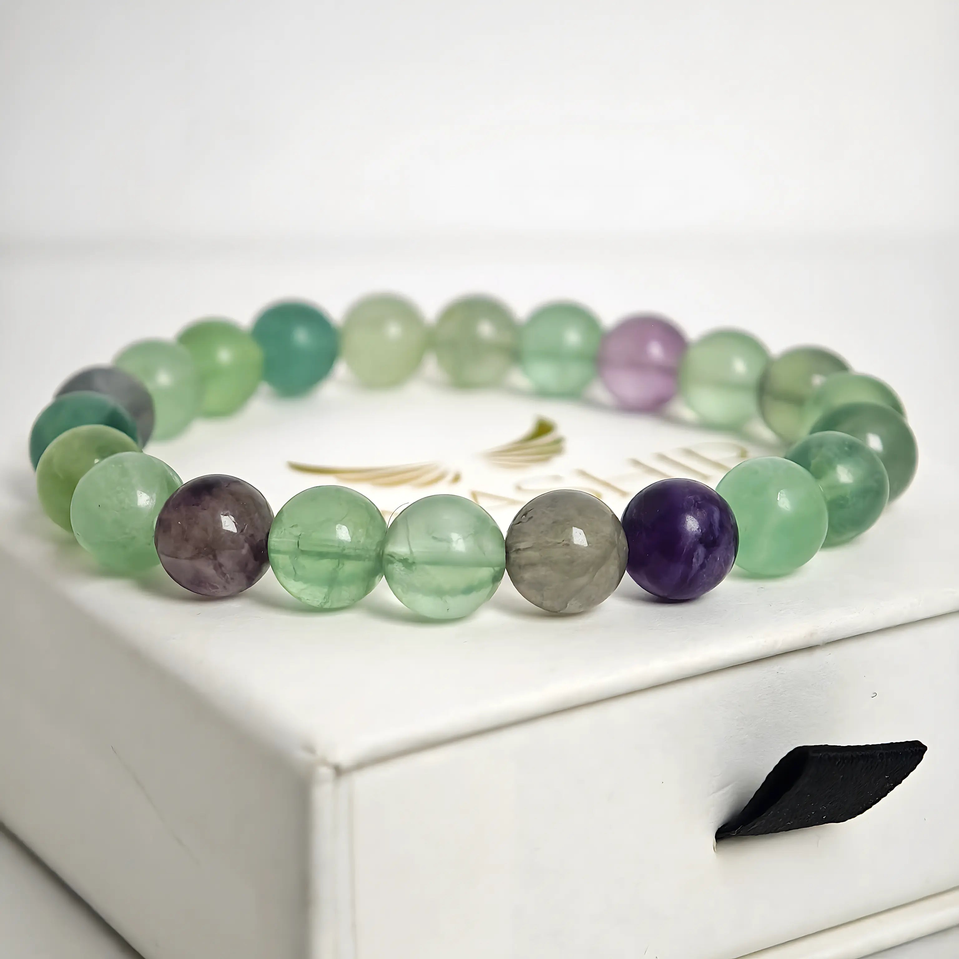 Close up of fluorite bracelet beads showing natural green and purple tones