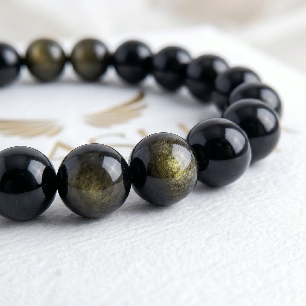 gold obsidian bracelet natural stone beads close up golden shimmer