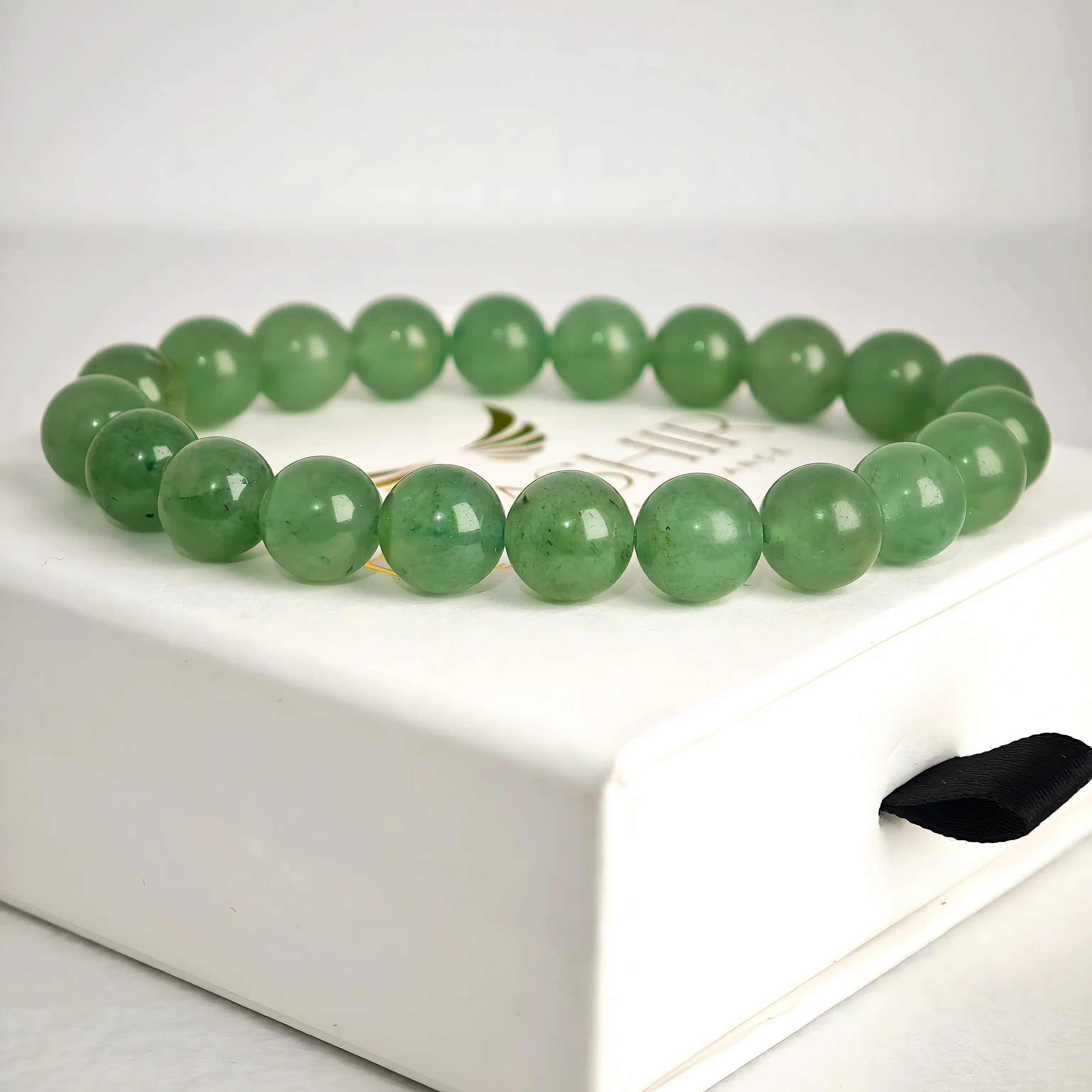 Close up of green aventurine bracelet beads showing smooth natural texture