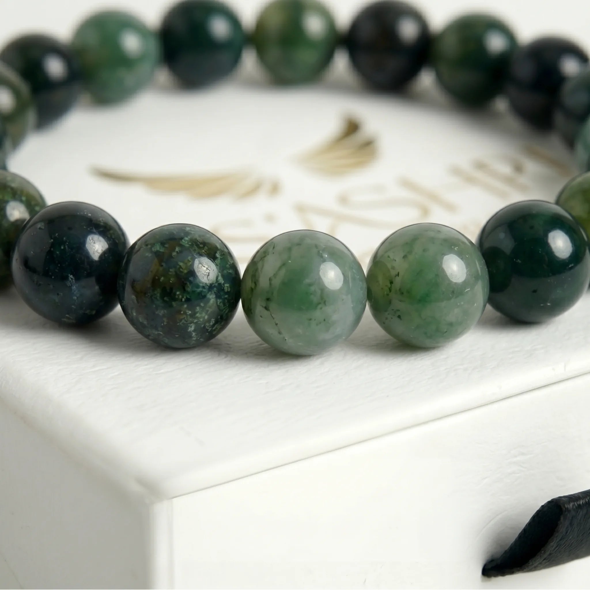 moss agate bracelet natural stone beads close up green white pattern