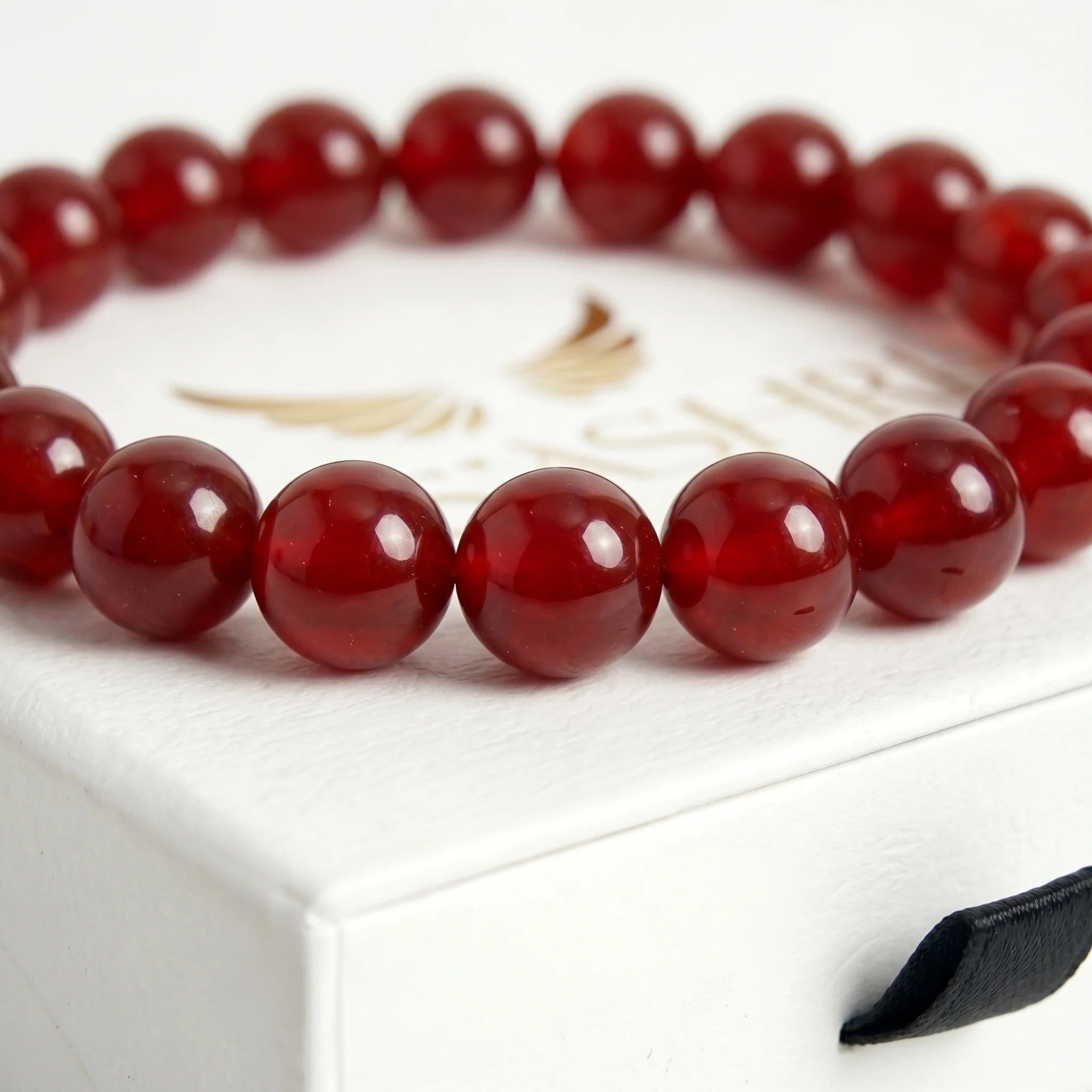 red agate bracelet natural stone beads close up deep red banding