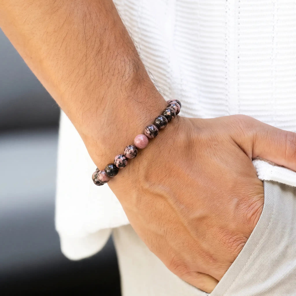 Rhodonite bracelet worn on man's wrist — unisex emotional balance stone bracelet