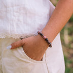 Rhodonite bracelet worn on woman's wrist — self-love natural stone bracelet Kaashir