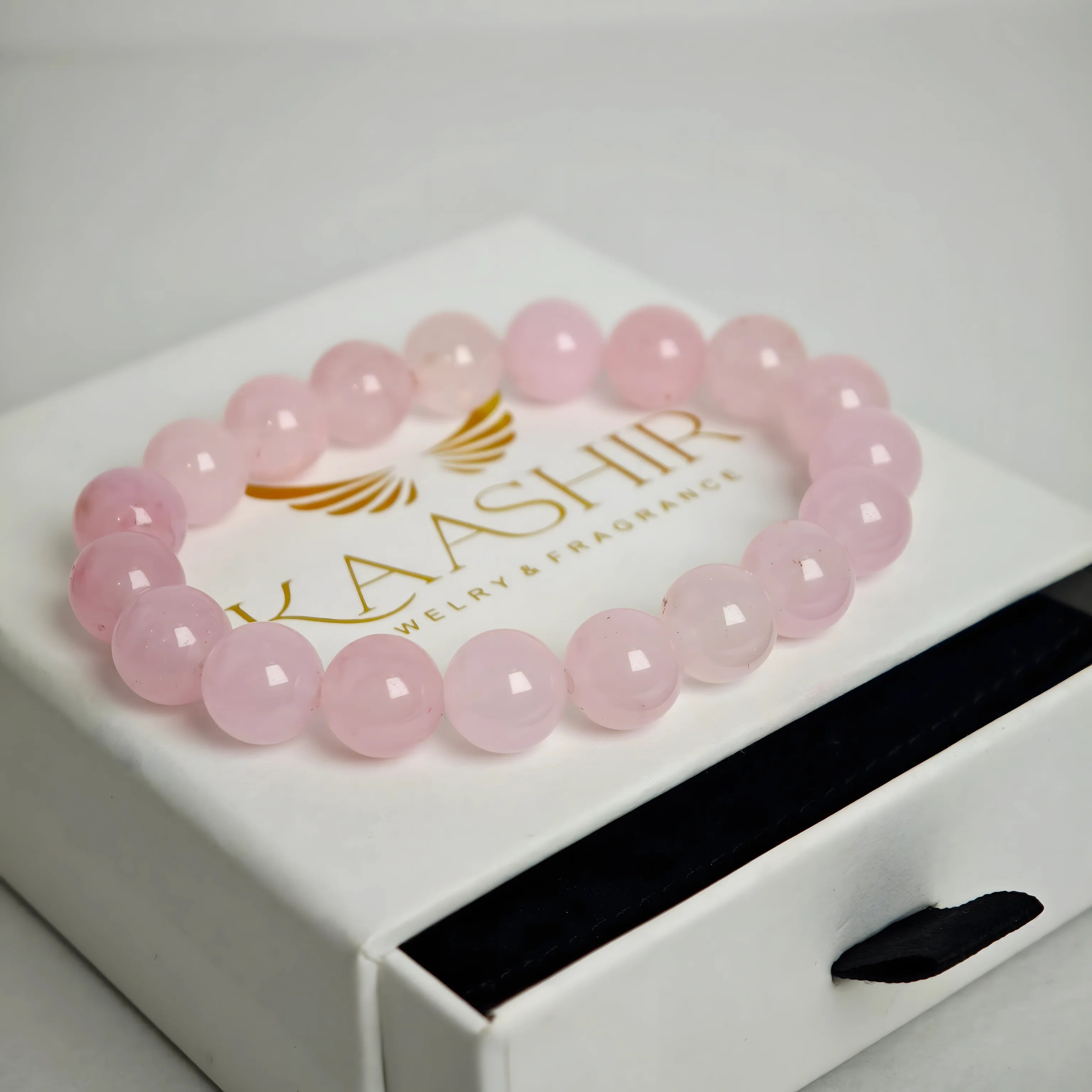 Rose Quartz bracelet in flat lay with luxury aesthetic styling and soft tones
