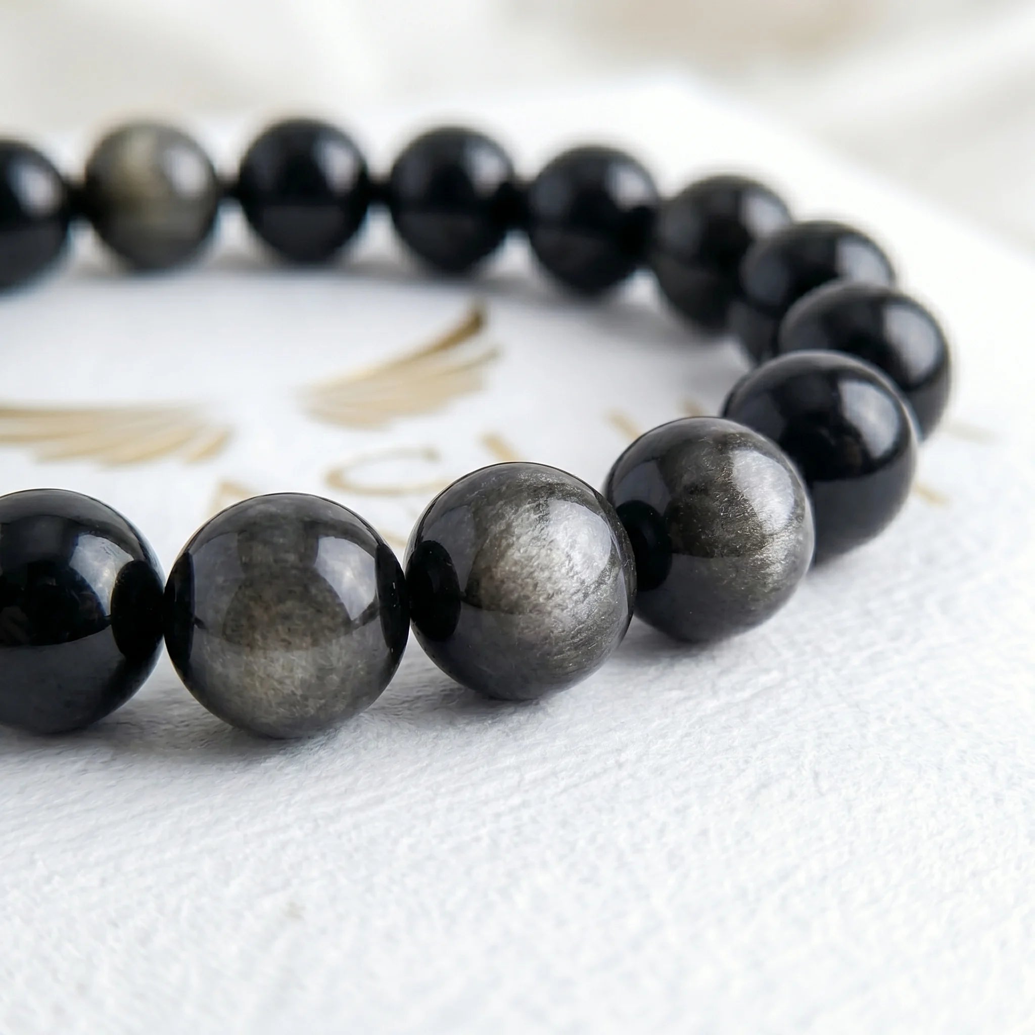 silver obsidian bracelet natural stone beads close up silver shimmer