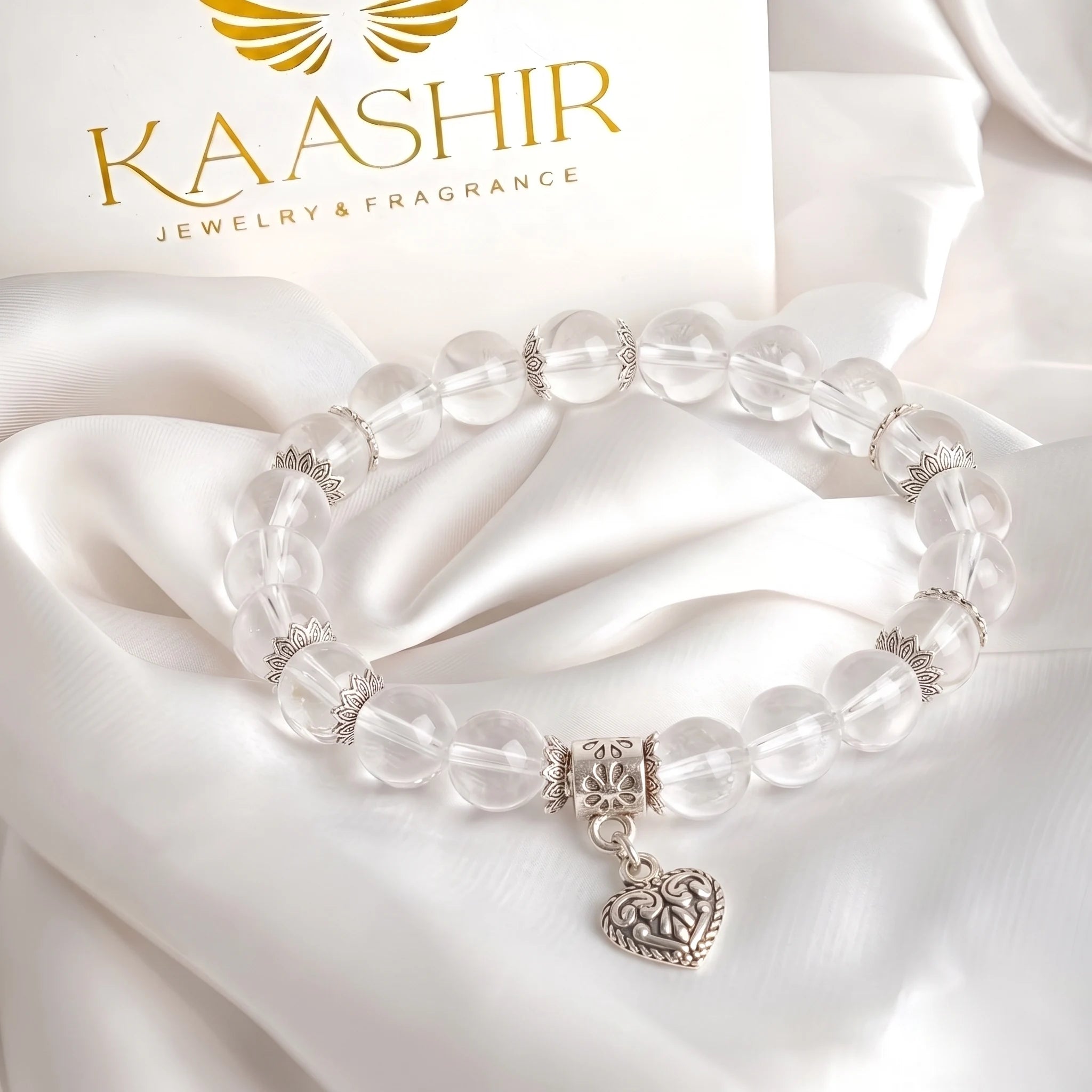 Sterling silver heart charm detail on clear quartz beaded bracelet — handmade by Kaashir