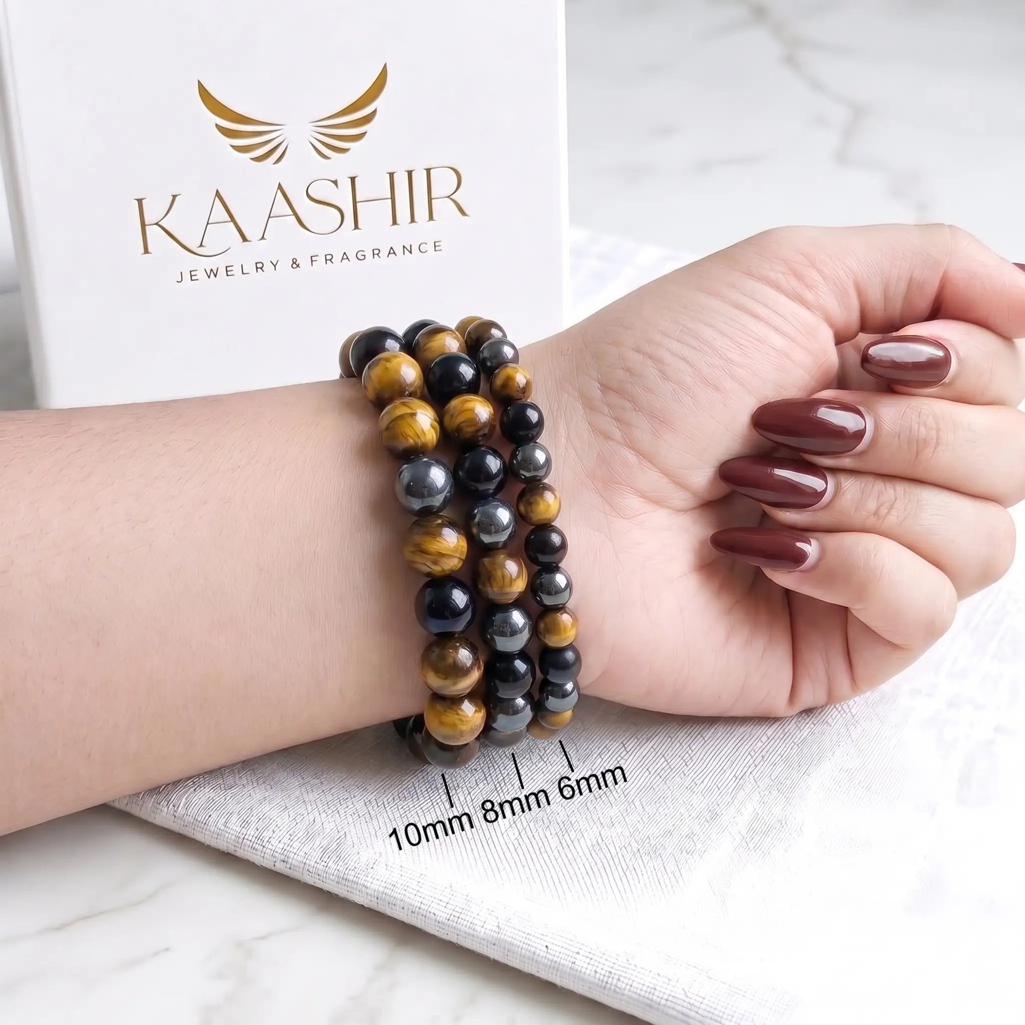 Triple protection bracelet on mens wrist with tiger eye obsidian hematite