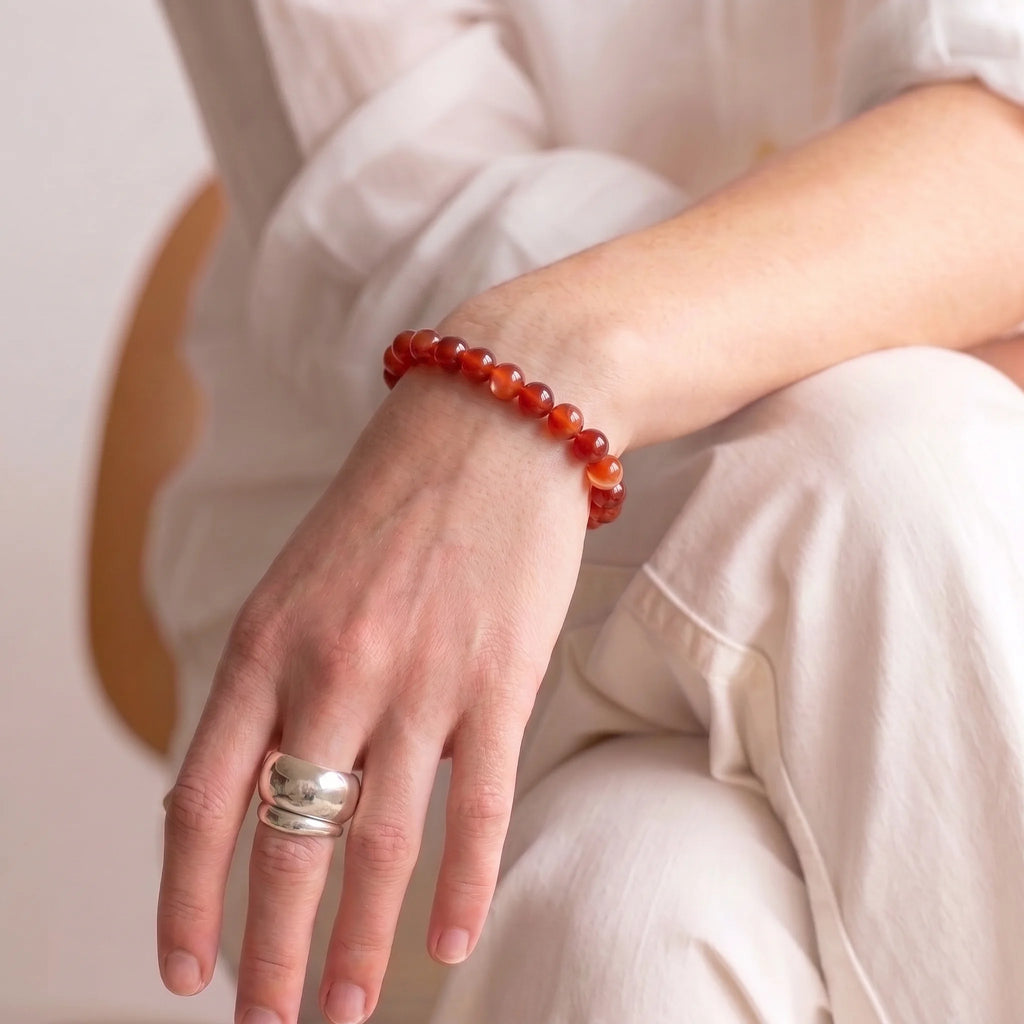 Woman wearing red banded agate bracelet - handmade grounding bracelet for women