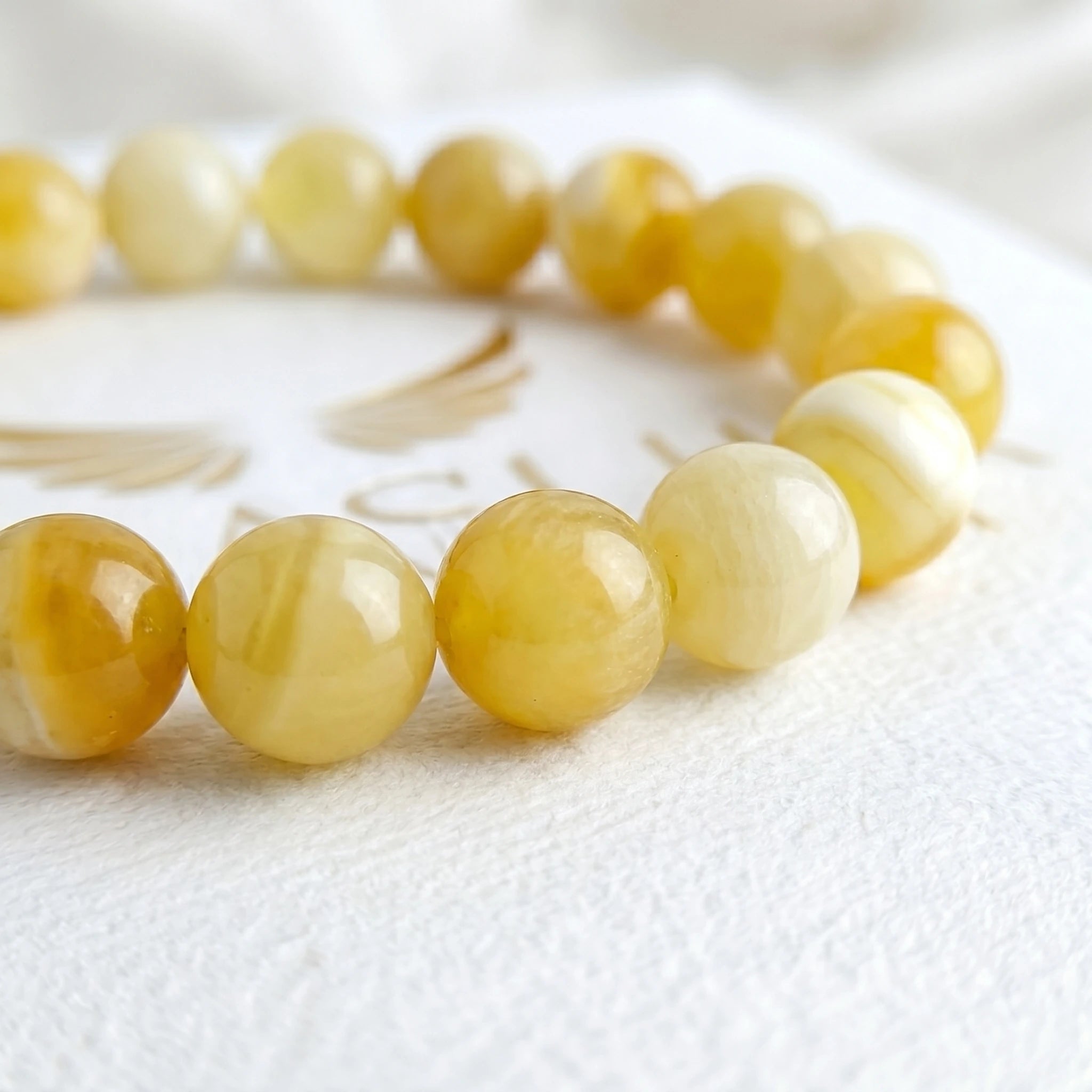yellow jade bracelet natural stone beads close up warm golden tones