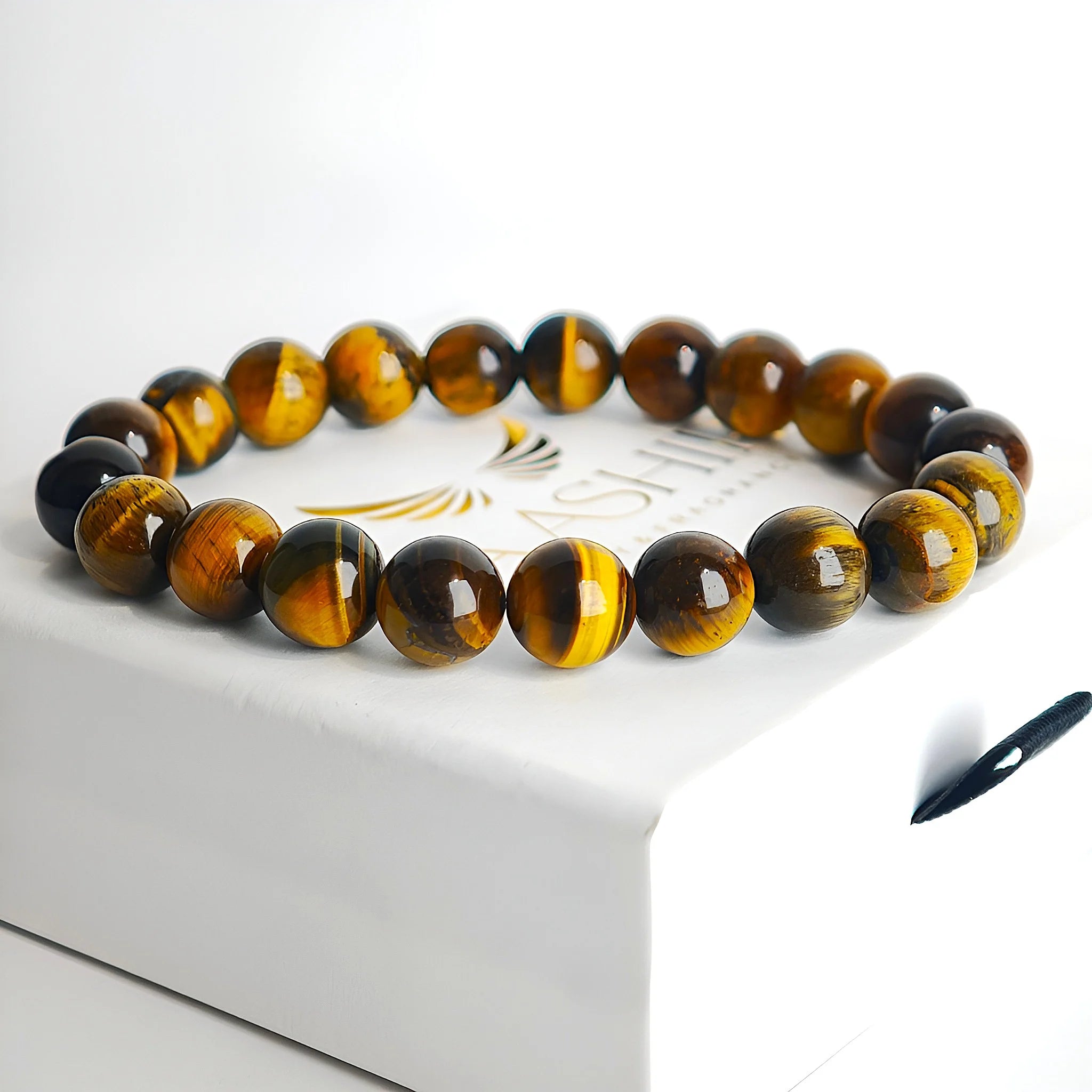 Close-up of yellow tiger eye bracelet showing golden brown natural stone bead texture